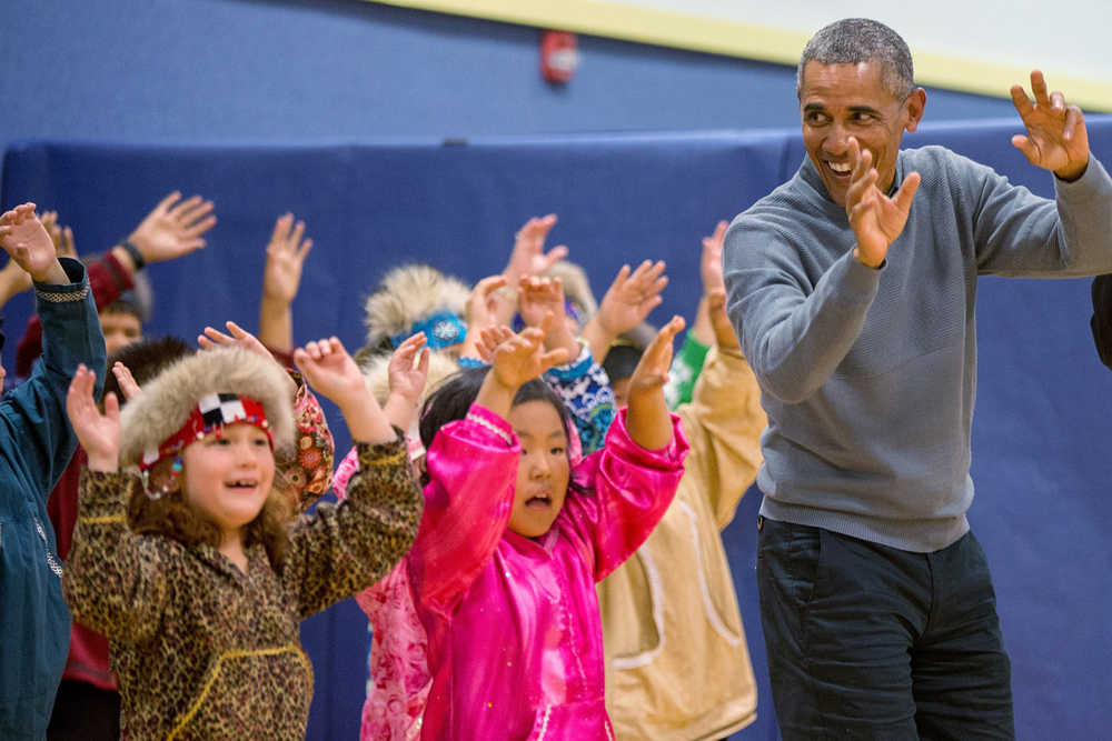President Barack Obama participates in a performance by native Alaskan dancers at Dillingham Middle School, Wednesday, Sept. 2, 2015, in Dillingham, Alaska. Obama is on a historic three-day trip to Alaska aimed at showing solidarity with a state often overlooked by Washington, while using its glorious but changing landscape as an urgent call to action on climate change. (AP Photo/Andrew Harnik)