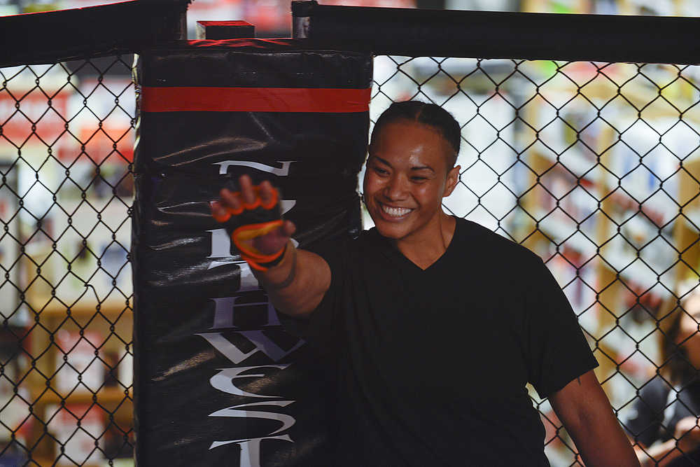 Photo by Rashah McChesney/Peninsula Clarion  Baybe Fanene waves to the audience before her fight on Saturday Sept. 5, 2015 during the Peninsula Fighting Championships mixed martial arts fights at the Peninsula Center Mall in Soldotna, Alaska.