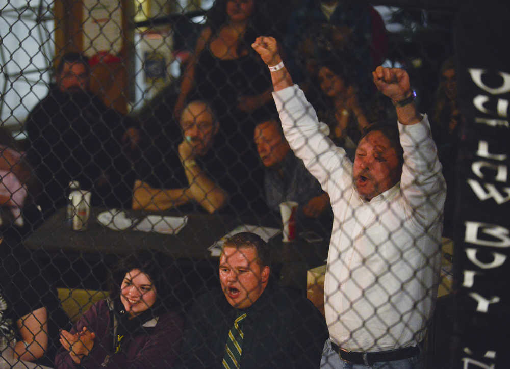 Photo by Rashah McChesney/Peninsula Clarion  Members of the audience cheer after Felix Bobby submits Cole Aquino during the first round of their fight on Saturday Sept. 5, 2015 at the Peninsula Center Mall in Soldotna, Alaska.