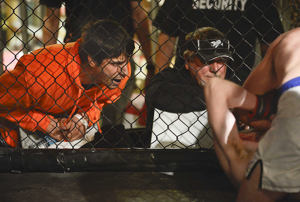 Photo by Rashah McChesney/Peninsula Clarion  Michael Anderson, of Sterling, yells instructions to a teammate during a fight on Saturday Sept. 5, 2015 during the Peninsula Fighting Championship mixed martial arts fights at the Peninsula Center Mall in Soldotna, Alaska.