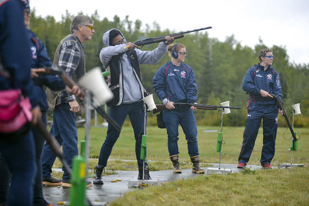 Photo by Rashah McChesney/Peninsula Clarion ...., of Eagle River, laughs as Elaina Spraker coaches her through shooting trap on Tuesday Sept. 8, 2015 at the Snowshoe Gun Club in Kenai, Alaska.