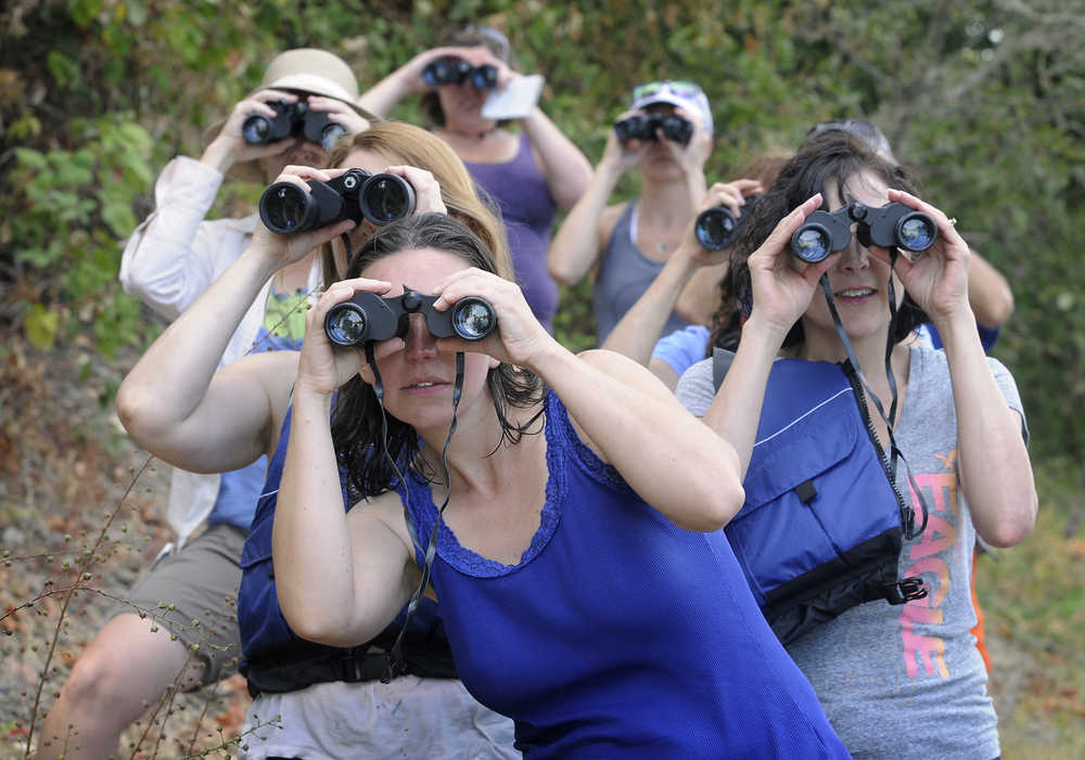 ADVANCE FOR WEEKEND EDITIONS, SEPT. 5-6 - In this photo taken Thursday, Aug. 27, 2015, Athena Lodge, center, a third and fourth grade teacher at Kings Valley Charter School, and fellow teachers learn how to use binoculars during a birding stop, part of an education program coordinated by the Institute of Applied Ecology,  along the Willamette River near Corvallis, Ore. (Andy Cripe/The Corvallis Gazette-Times via AP) MANDATORY CREDIT