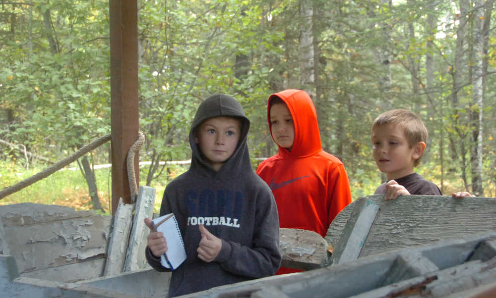 Photo by Megan Pacer/Peninsula Clarion From left to right: Connor Kniceley, 8, Vann Poage, 8, and Justice Aseltine, 8, get a closer look at a boat named "Stormrunner" during the field trip on Thursday, Sept. 10, 2015 at the Soldotna Homestead Museum in Soldotna, Alaska.