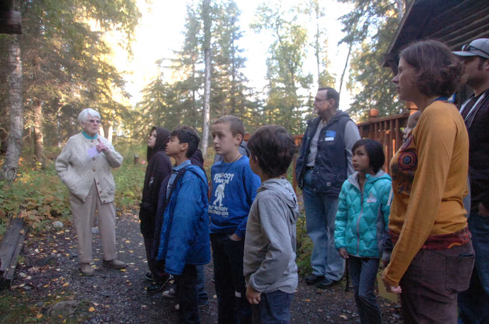 Photo by Megan Pacer/Peninsula Clarion Soldotna's first female homesteader Marge Mullen, left, guides third and fourth grade Soldotna Elementary students on a tour through relocated cabins on Thursday, Sept. 10, 2015 at the Soldotna Homestead Museum in Soldotna, Alaska.