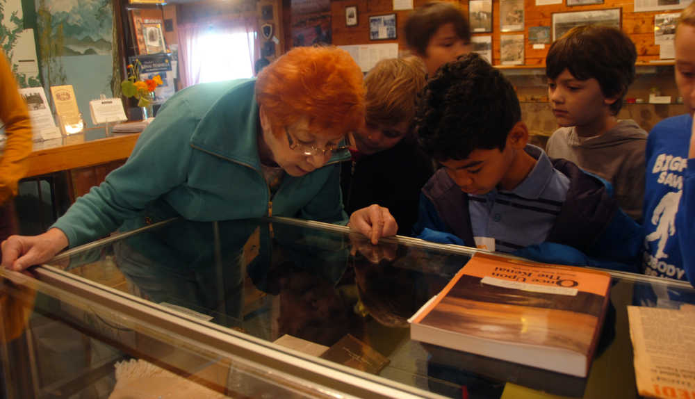 Photo by Megan Pacer/Peninsula Clarion Volunteer Carroll Knutson points out and describes several artifacts to students from Soldotna Elementary during their field trip on Thursday, Sept. 10, 2015 at the Soldotna Homestead Museum in Soldotna, Alaska.