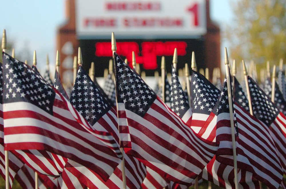 Ben Boettger/Peninsula Clarion A display of flags waves commemorating the Sept.11, 2001 terrorist attacks wave on Friday, Sept. 11 in front of Nikiski's Fire Station 1.