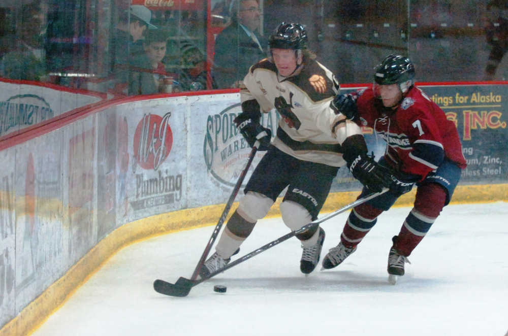 Ben Boettger/Peninsula Clarion  and  vie for the pock during a game on Friday, Sept. 11 at the Soldotna Sports Center.