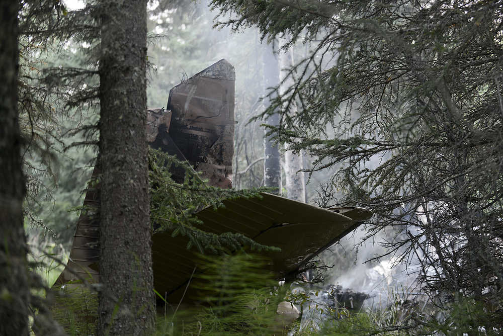 Ben Boettger/Peninsula Clarion The tail of a crashed plane sits the woods on Saturday, August 22 at a crash site near South Cohoe Loop Road.