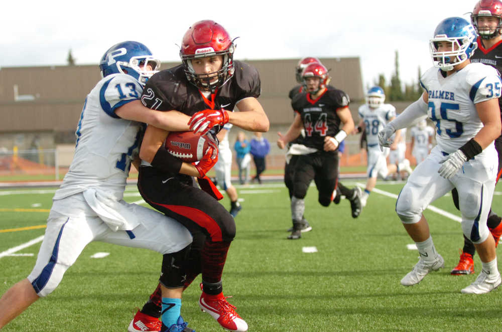 Ben Boettger/Peninsula Clarion Palmer football player Justin Roth tackles Kenai's Zach Tuttle during at game on Saturday Sept. 19 at Kenai Central High School.