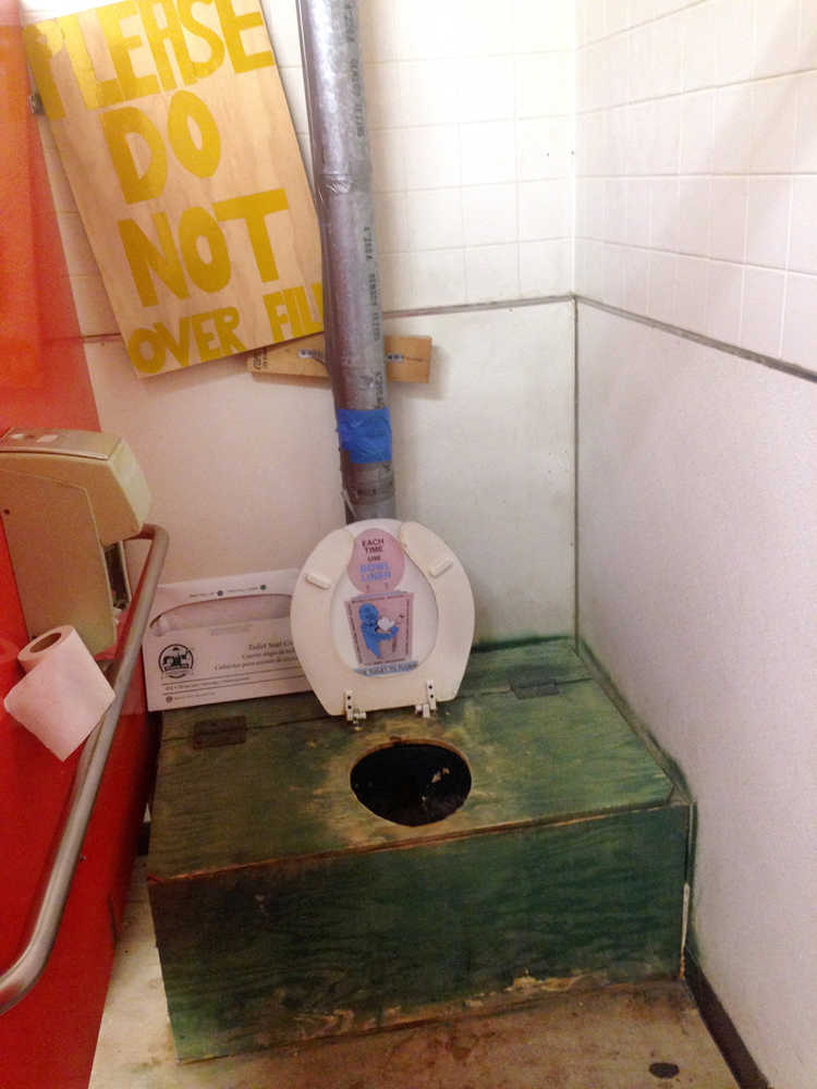 This Thursday, June 2, 2015 photo shows a so-called honey bucket _ a large bucket used as a toilet without running water _ at the tribal council office in the village of Kipnuk, Alaska. Flush toilets and running water remain elusive dreams for residents of at least 30 Alaska villages where indoor plumbing has historically cost hundreds of thousands of dollars to install in just one home. (Corey DiRutigliano, Cold Climate Housing Research Center via AP)