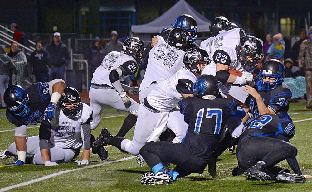 Nikiski running back Rykker Riddall (28) carries the ball during the Bulldogs' 28-21 win over the Thunder Mountain Falcons in Juneau on Friday. Bulldog's blockers Luke Johnson (54), Corin Cooper (29), Jon McCormick (58), Ian Johnson (4) and Rueben Sepeda (75) opened the hole.