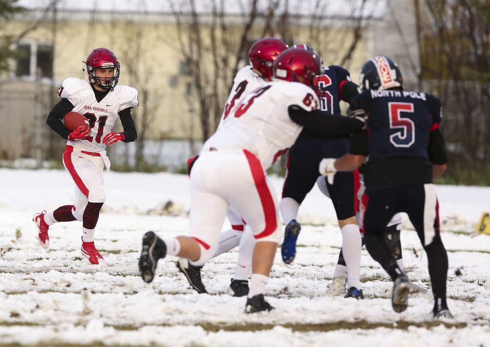 Kenai's Zach Tuttle runs the ball during a game against North Pole at North Pole High School on Friday, September 25, 2015. ERIN CORNELIUSSEN/NEWS-MINER