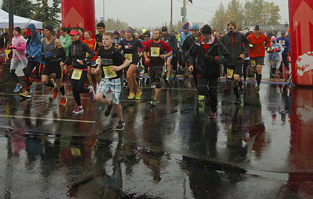 Photo by Megan Pacer/Peninsula Clarion Runners take off at the start of a half marathon on Sunday, Sept. 27, 2015 during the annual Kenai River Marathon at the Kenai Chamber of Commerce and Visitor Center in Kenai, Alaska.