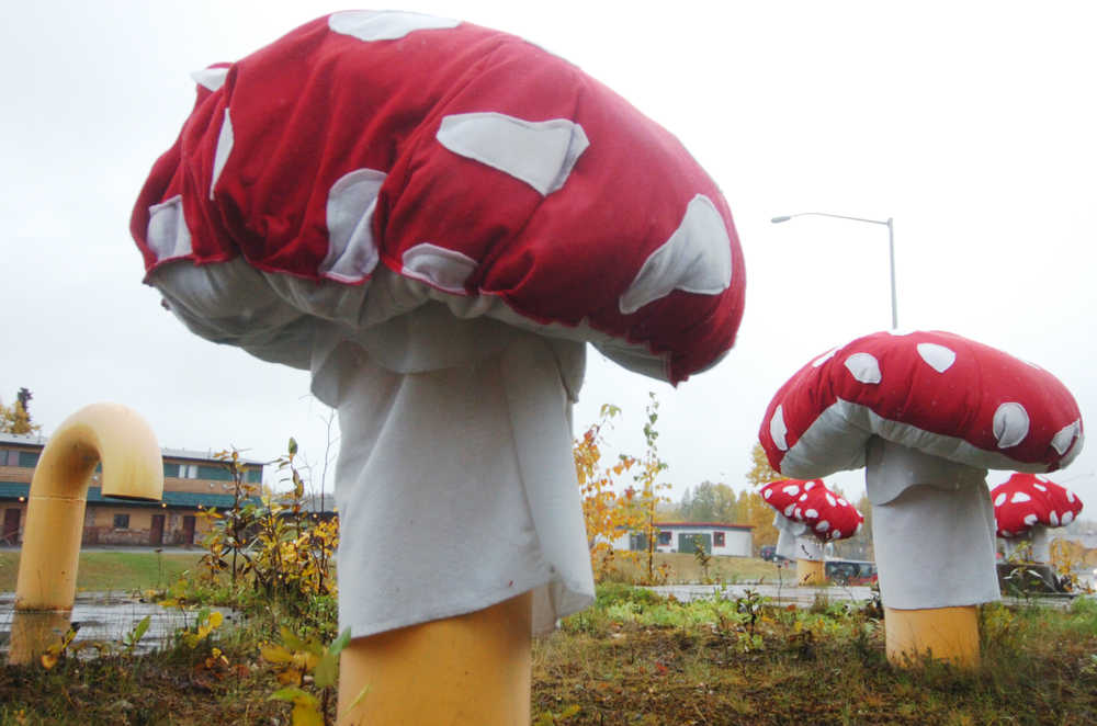 Ben Boettger/Peninsula Clarion Plush caps mushroom caps cover concrete posts protecting a water conduit access hatch near Mountain Mama Originals craft shop on Tuesday, September 29 by the Sterling Highway in Soldotna. Susanna Evins, a seamstress at the shop, made the caps out of recycled plastic and scraps from the store.