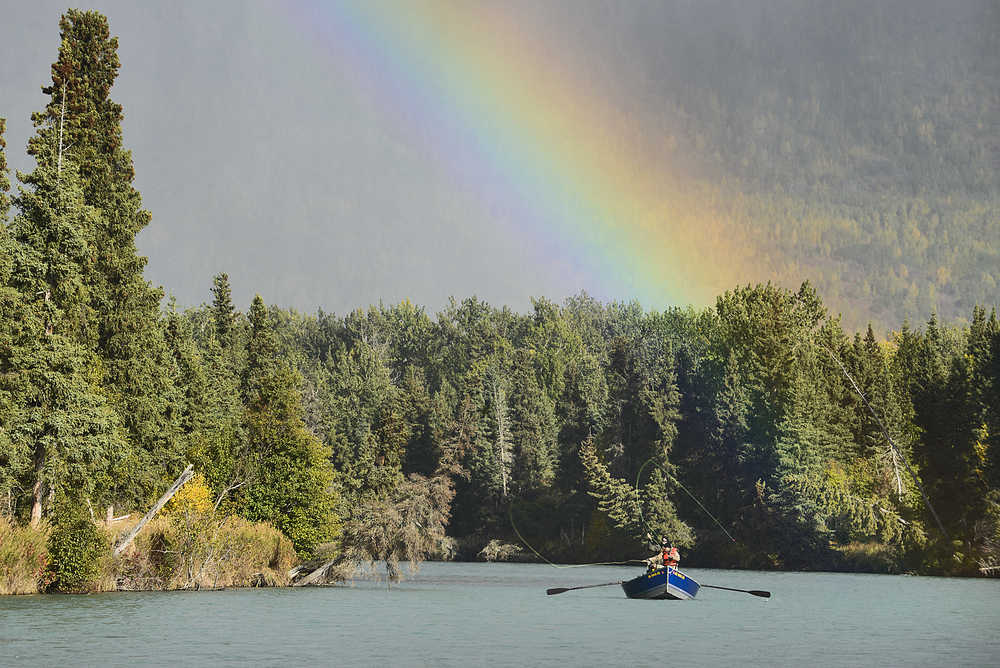 Photo by Rashah McChesney/Peninsula Clarion Anglers fish below a rainbow on the upper Kenai River near its outlet into Skilak Lake on Sept. 21, 2015 near Cooper Landing, Alaska.
