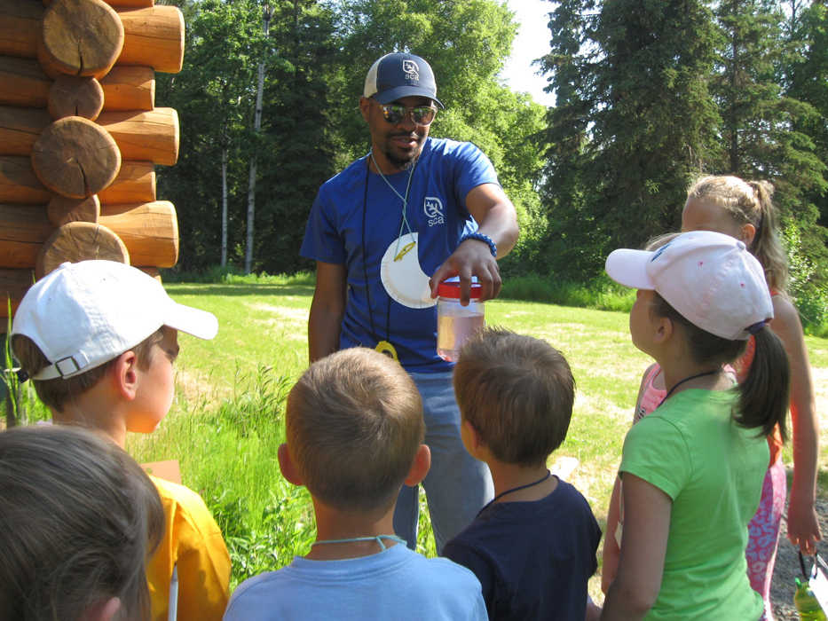 Second and third grade participants in this summer's Critter Camp learn how salmon transform as they migrate from saltwater to freshwater enroute to their birth stream.  (Photo courtesy Kenai National Wildlife Refuge)