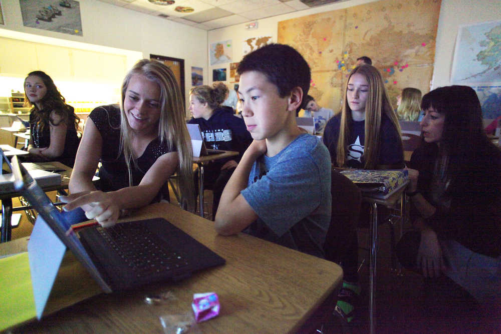 Photo by Kelly Sullivan/ Peninsula Clarion (Left) Ninth graders Brittany Taylor and Sam Skolnick discuss map layers in Nathan Erfruth's geography class during the two-day course in Geographical Information System taught by members of the Kenai Peninsula GIS User Group Friday, Sept. 25, 2015, at Soldotna Prep in Soldotna, Alaska.