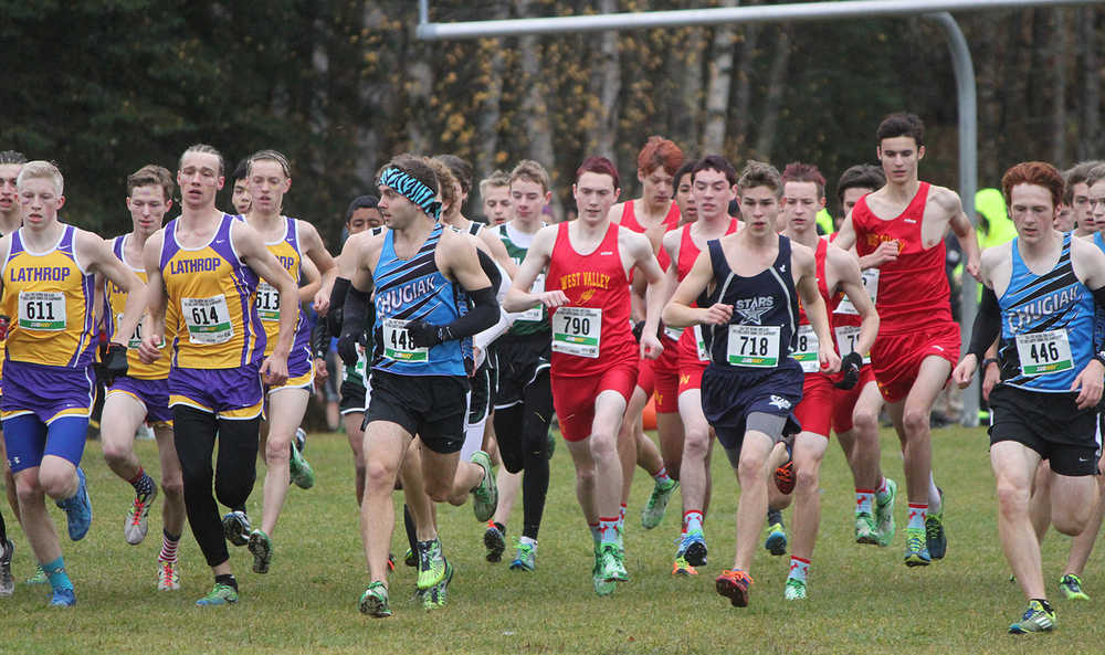 Photo by Joey Klecka/Peninsula Clarion Chugiak senior Ty Jordan (448) and Soldotna senior Aaron Swedberg (718) lead the charge at the start of Saturday's Class 4A boys state championship race at Bartlett High School in Anchorage. Jordan won the race while Swedberg placed eighth.