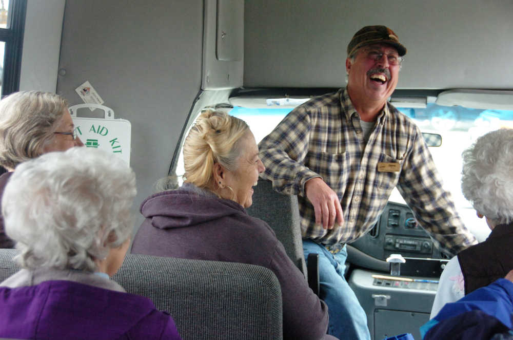 Photo by Megan Pacer/Peninsula Clarion Volunteer Steve Latz jokes with members of the Kenai Senior Center while  teaching them about the oil industry during one of his monthly Mystery Drives on Monday, Oct. 5, 2015, through Nikiski, Alaska.