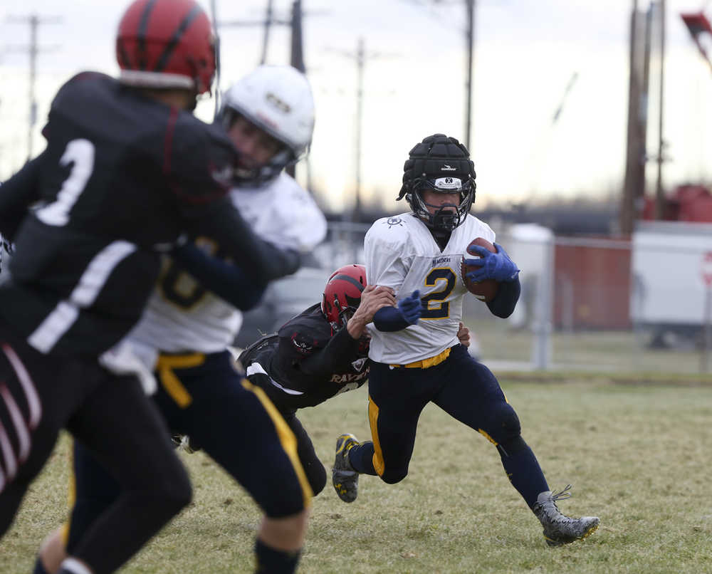 Homer's Michael Swoboda tries to run the ball during a small schools semifinal game at Eielson High School on Saturday, October 10, 2015. Eielson will be competing in the small schools state championship game next weekend at Dimond High School in Anchorage. ERIN CORNELIUSSEN/NEWS-MINER