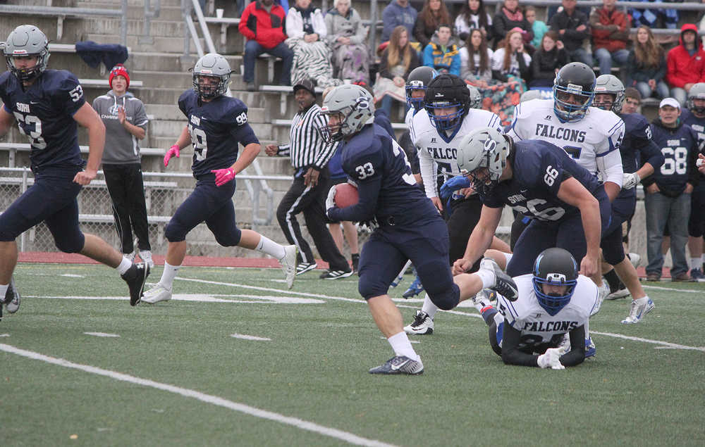 Photo by Joey Klecka/Peninsula Clarion Soldotna running back Mason Prior (33) shakes off a Thunder Mountain defender during Saturday's state medium-schools semifinal at Dimond Alumni Field in Anchorage.