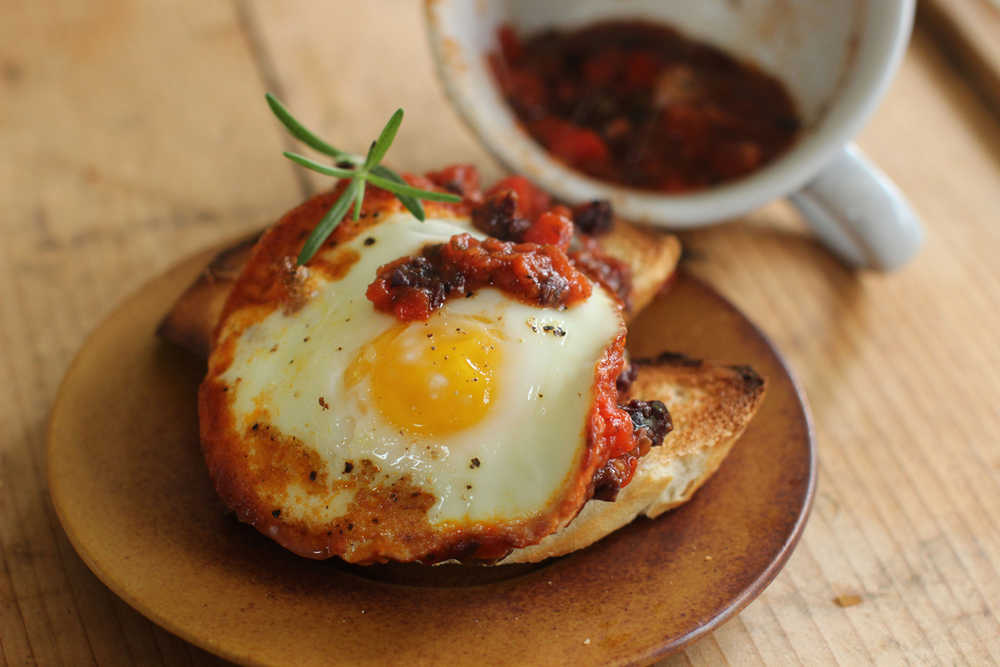 This Sept. 21, 2015, photo shows baked eggs in sweet pepper sauce in Concord, N.H. The sauce for these baked eggs uses healthy fast foods you can keep in your pantry, such as jarred roasted red peppers and simple marinara sauce. (AP Photo/Matthew Mead)