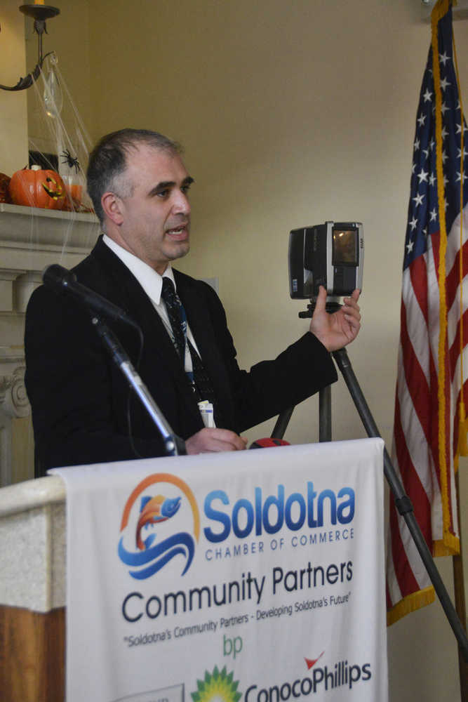 Photo by Megan Pacer/Peninsula Clarion Investigator Ramin Dunford with the Alaska State Troopers demonstrates how to use a FARO Focus 3D laser scanner at a Soldotna Chamber of Commerce Luncheon on Tuesday, Oct. 13, 2015 at Froso's Family Dining in Soldotna, Alaska.