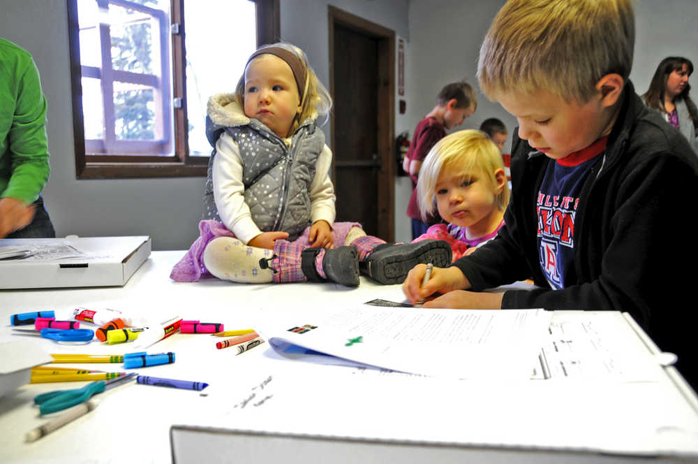 (From right) Aliya, Maisy and Isaiah Dickson work on Isaiah's project for the IDEA homeschool group's geography club weekly meetup Friday.