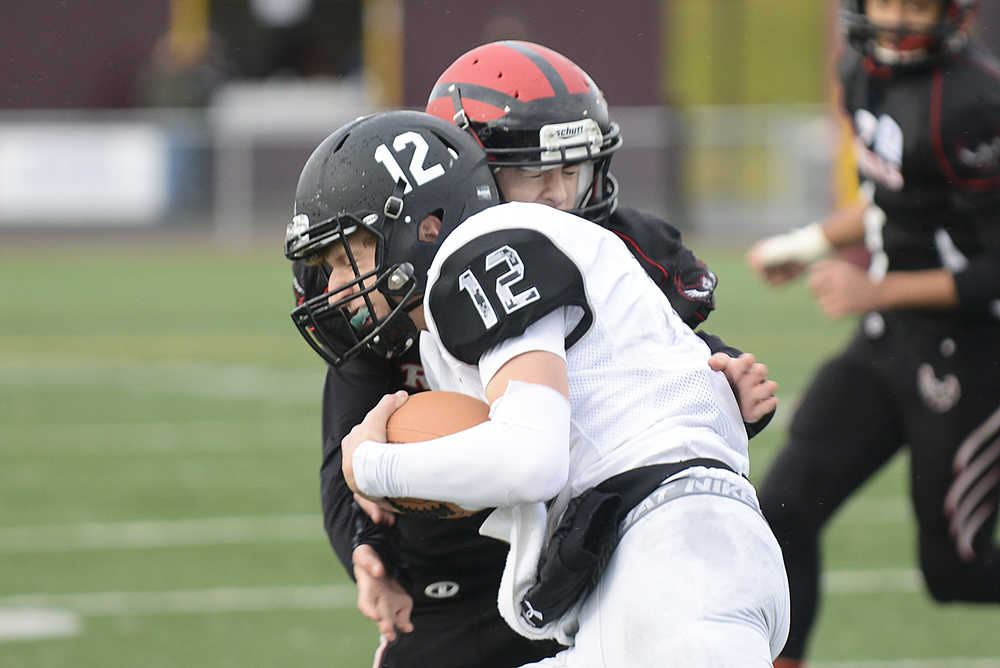 Photo by Rashah McChesney/Peninsula Clarion  Nikiski quarterback Dennis Anderson makes a run during their small schools state championship game against Eielson High School on Saturday Oct. 17, 2015 in Anchorage, Alaska.