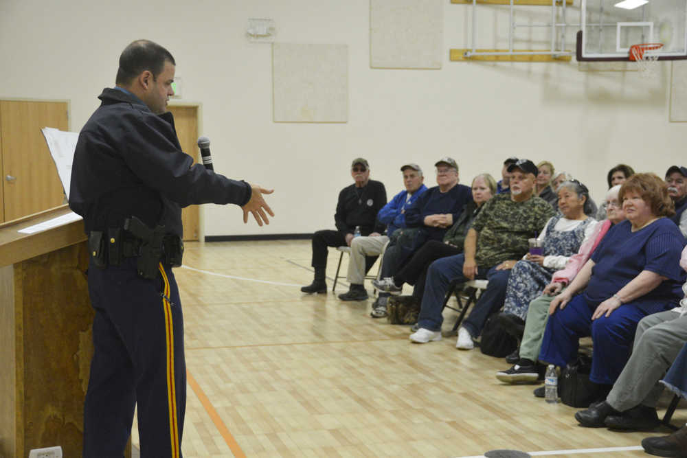 Photo by Megan Pacer/Peninsula Clarion Lt. Dane Gilmore of the Alaska State Troopers addressed a crowd of about 100 Sterling residents during a community meeting on Saturday, Oct. 10, 2015 at the Sterling Community Center.