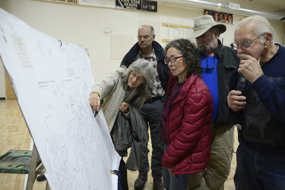 Photo by Megan Pacer/Peninsula Clarion Sterling residents gather around a map of the community to add black dots to indicate locations where thefts or burglaries have occurred. The map was presented at a community meeting on Saturday, Oct. 10, 2015 at the Sterling Community Center where about 100 people came to listen to their options for protecting against property crimes.