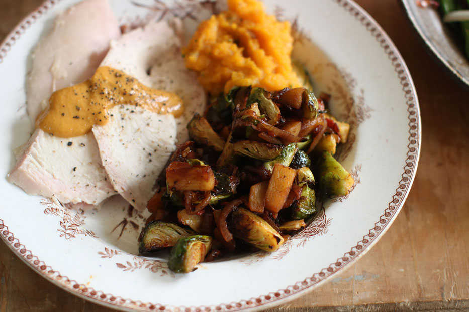 This Sept. 28, 2015, photo shows lighten up Brussels sprouts with bacon in Concord, N.H. This recipe allows for a crispy texture of the Brussels sprouts without frying. (AP Photo/Matthew Mead