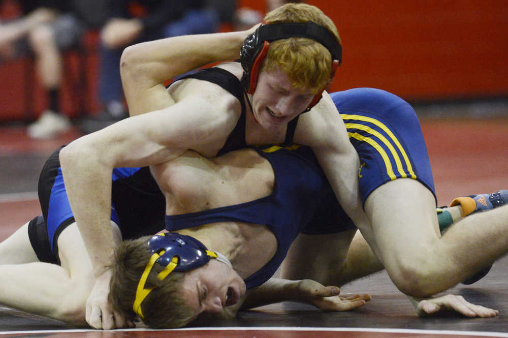 Photo by Kelly Sullivan/ Peninsula Clarion In this November 25, 2014 file photo,  Soldotna High School Star Talon Musgrave struggles against Homer Mariner Julien Richburg in the 145-pound weight class match during the Luke Spruill Memorial Wrestling Tournament at Kenai Central High School in Kenai, Alaska.