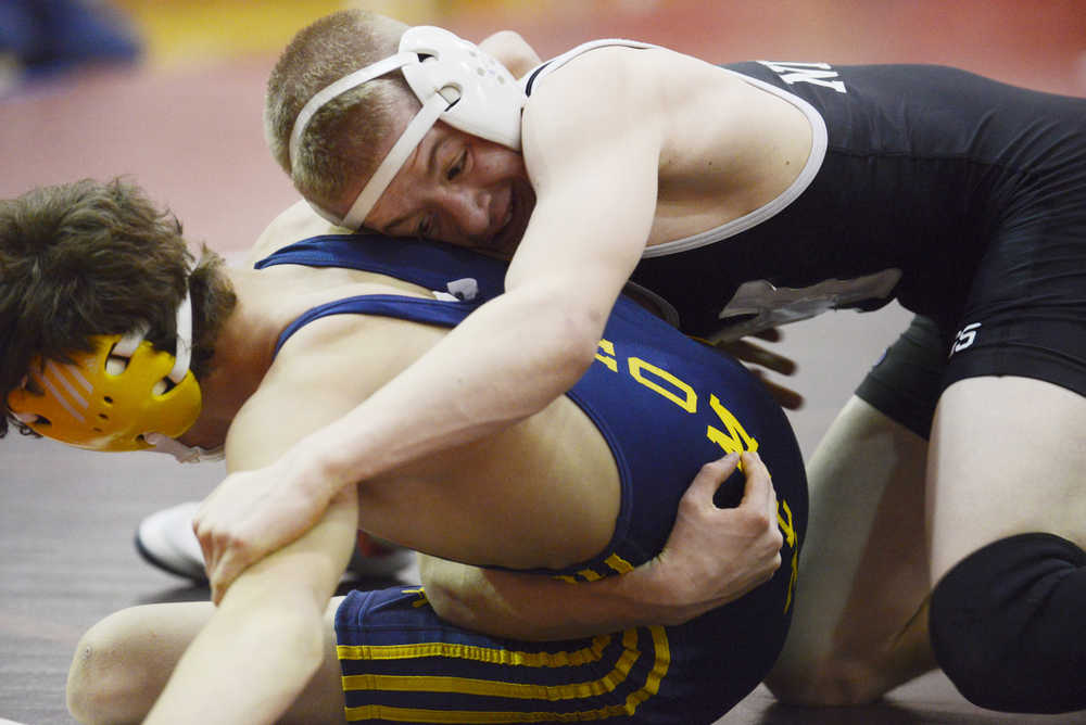 Photo by Kelly Sullivan/ Peninsula Clarion In this Nov. 25, 2014 file photo, Nikiski Bulldog TJ Cox tries to pin Homer Mariner Jared Brant in the 120-pound weight class match during the Luke Spruill Memorial Wrestling Tournament at Kenai Central High School in Kenai, Alaska.