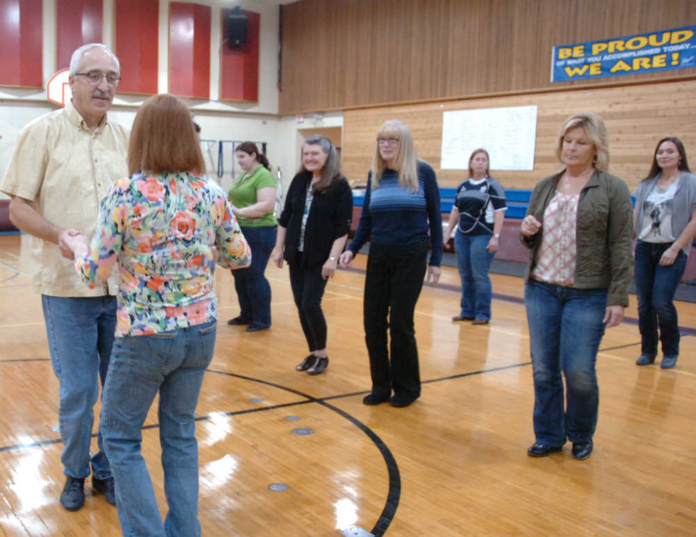 Photo by Megan Pacer/Peninsula Clarion Instructor Raymond Hanson leads a group of about 15 people in swing and cha cha lessons during a class hosted through the Soldotna Community Schools Program on Thursday, Oct. 22, 2015 at the Soldotna Prep School in Soldotna.