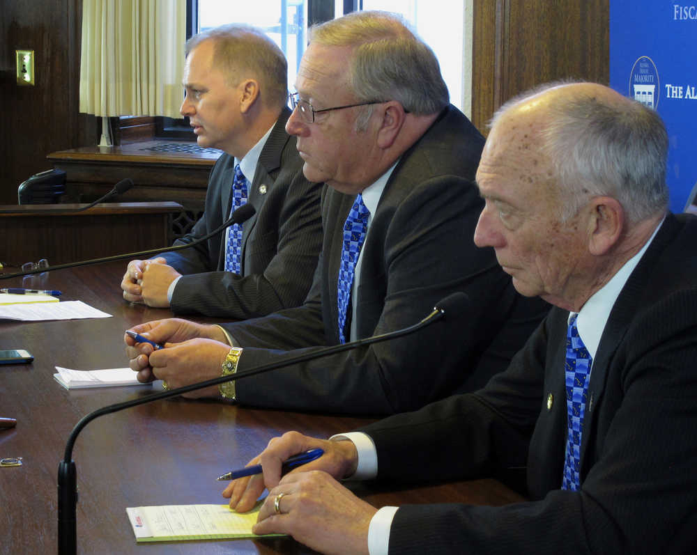 Members of the Alaska House majority speak to members of the media on the first day of the Legislature's third special session this year on Saturday, Oct. 24, 2015, in Juneau, Alaska. The focus of the special session is on the proposed buy out of TransCanada Corp. from the gas project the state is pursuing. Pictured from the top are Reps. Mark Neuman, Mike Chenault and Steve Thompson. Neuman and Thompson are co-chairs of the House Finance Committee; Chenault is the House speaker. (AP Photo/Becky Bohrer)