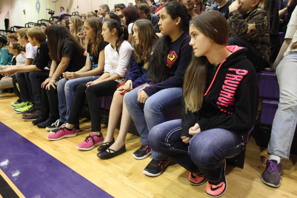 Photo by Kelly Sullivan/ Peninsula Clarion Cyanna Lindquist, Shae Breff and Zaharah Wilshusen watch speaker Michael Patterson talk about his experience smoking cigarettes during an assembly Wednesday, Oct. 28, 2015, at Kenai Middle School in Kenai, Alaska.