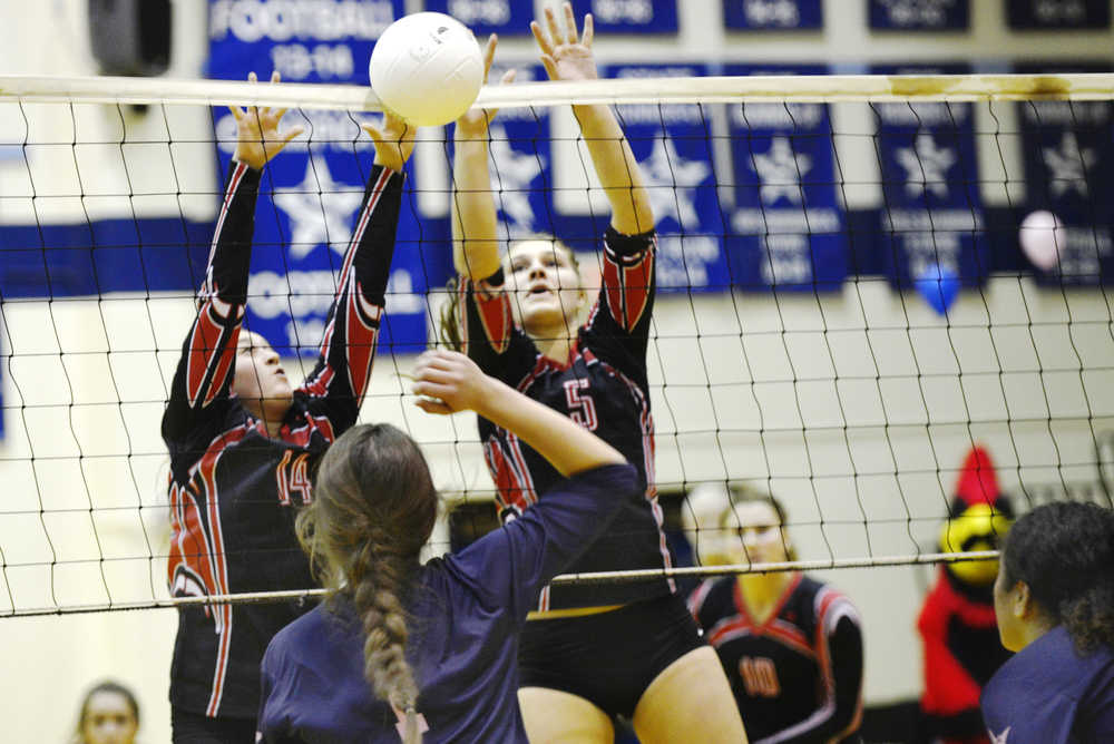 Ben Boettger/Peninsula Clarion Kenai volleyball players Jacey Ross (left) and Emily Koziczkowski tip the ball towards Soldotna's Anna Aley during a game at Soldotna High School on Friday, Oct. 30.