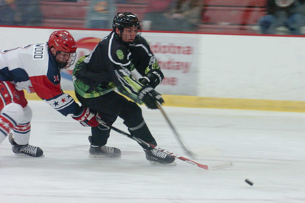 Photo by Rashah McChesney/Peninsula Clarion Kenai River Brown Bear Tanner Dufault outmaneuvers an Aston Rebels player during their game on Friday October 30, 2015 in Soldotna, Alaska.