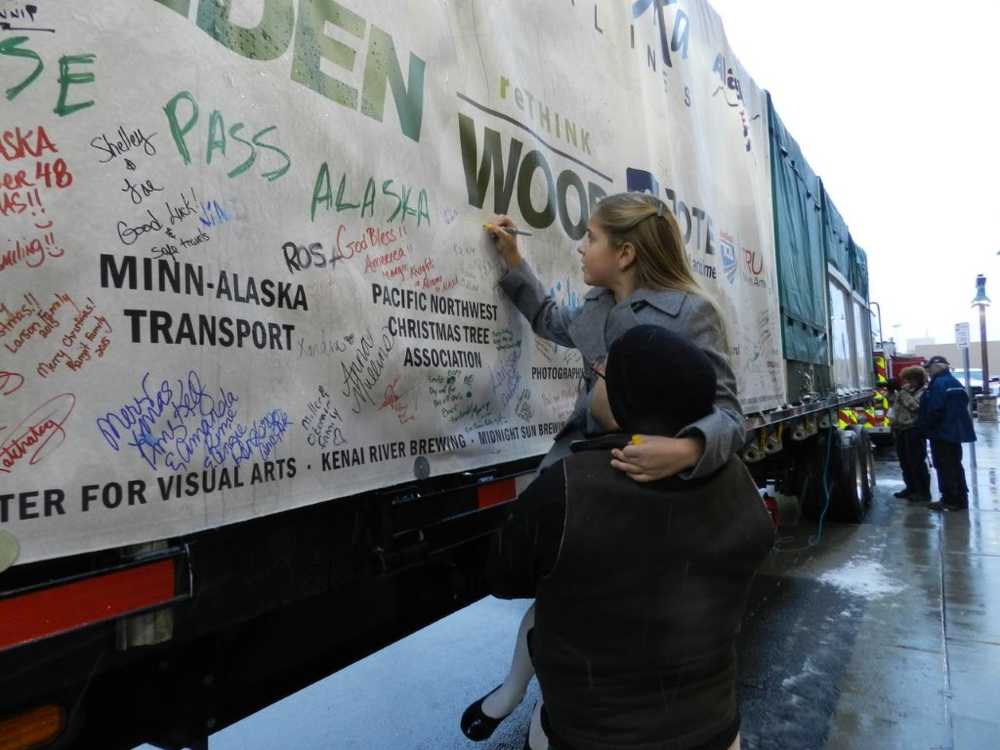 Photo courtesy Shona DeVolld Anna DeVolld and her sister Sara DeVolld pose with Sen. Lisa Murkowski in front of the banner that will be send to Washington DC along with the Capitol Christmas Tree, Saturday, Oct. 31, 2015, in Anchorage, Alaska.