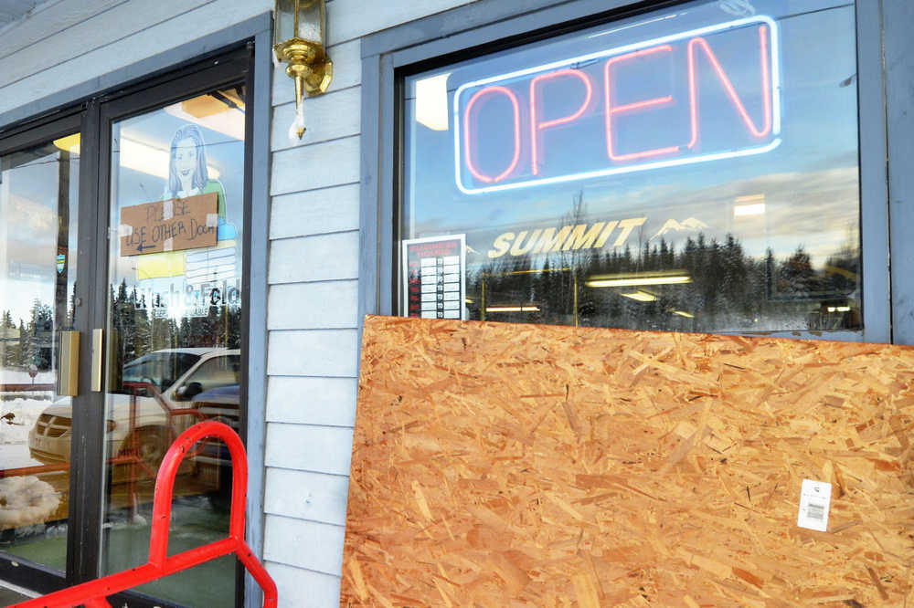 Megan Pacer/Peninsula Clarion In this Tuesday, Nov. 3 photo, a sheet of plywood covers the hole in the front of Kenai's Summit Drycleaners made when Christine Cunningham drove her car through the wall on Monday, Nov. 2 in Kenai.