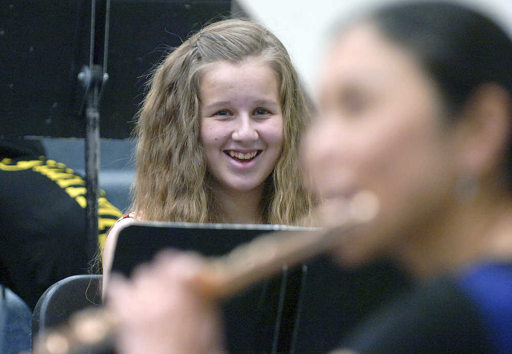 Photo by Rashah McChesney/Peninsula Clarion Anna Aley, sophomore flutist, laughs as Soldotna-based flutist Tomoka Raften plays a technically difficult modern piece by composer Ian Clarke during a band class on Wednesday Nov. 4, 2015 in Soldotna, Alaska. The song "Zoom Tube" is a blues-influenced piece that requires several techniques including playing multiple tones at once and singing while playing that had students laughing throughout Raften's performance. Raften and Kenai-based pianist Maria Allison will perform on Nov. 7 at the Soldotna Christ Lutheran Church.