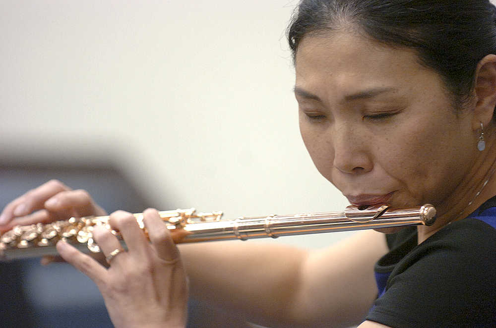 Photo by Rashah McChesney/Peninsula Clarion  Soldotna-based Flutist Tomoka Raften plays for a group of students on Wednesday Nov. 4, 2015 at Soldotna High School in Soldotna, Alaska. Raften and Kenai-based pianist Maria Allison will perform on Nov. 7 at the Soldotna Christ Lutheran Church.