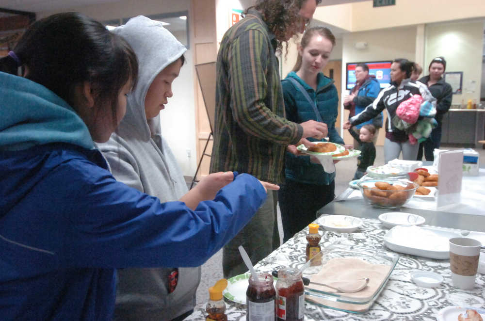 Photo by Megan Pacer/Peninsula Clarion Students and visitors enjoy locally-made fry bread during the kick-off event for Alaska Native/Native American Heritage Month on Thursday, Nov. 5, 2015 in the McLane Commons at Kenai Peninsula College.
