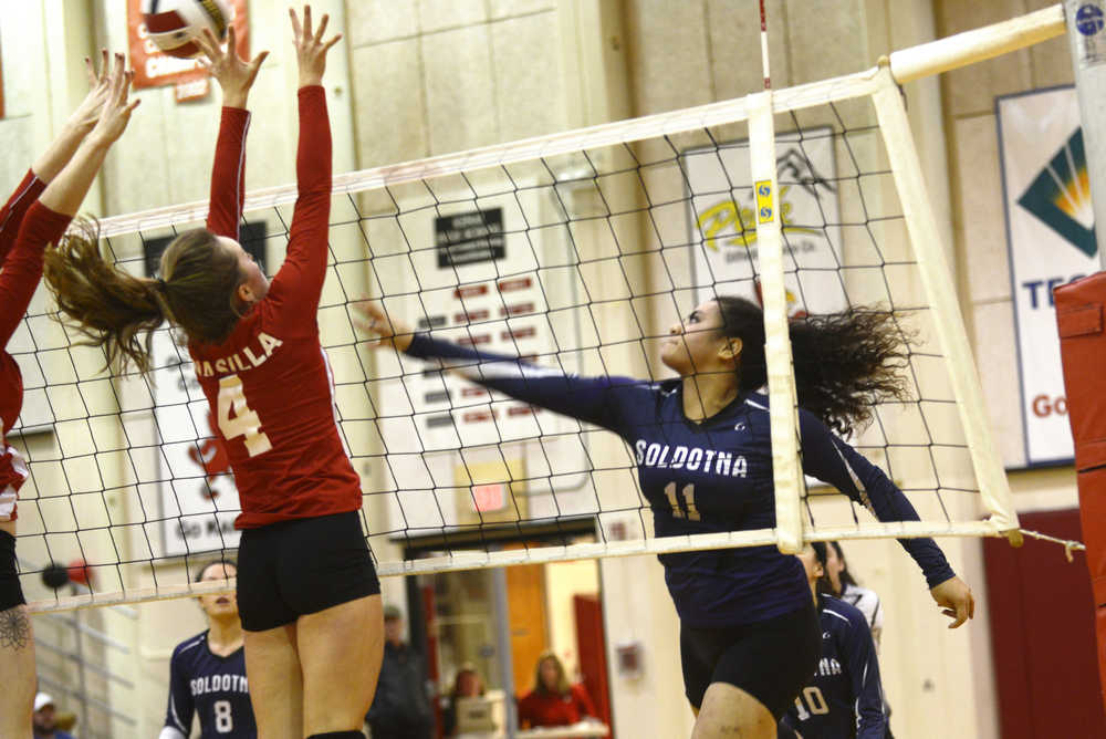 Ben Boettger/Peninsula Clarion Soldotna volleyball player Sylvia Tuisaula spikes the ball past Wasilla's Lindsey Cizek during a game against Wasilla on Thursday Nov. 5 at Kenai Central High School.