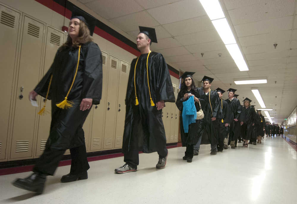 Photo by Rashah McChesney/Peninsula Clarion In this May 9, 2013 file photo Kenai Peninsula College Kenai River Campus graduates make their way to the ceremony at Kenai Central High School in Kenai, Alaska. Students at the community college - and the entire University of Alaska system - will see an increase in tuition in 2015.