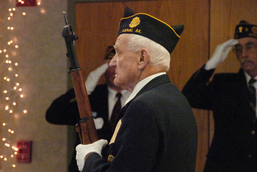 Photo by Megan Pacer/Peninsula Clarion Joe Coop, a member of the American Legion and the VFW, stands at attention during a flag raising ceremony on Tuesday, Nov. 10, 2015 at the Kenai Senior Citizens Center in Kenai, Alaska.