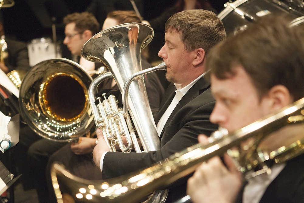 Matt Murphy (center) and Seth Bodine (right) play in the bass section of the University of Alaska Anchorage Wind Ensemble. The group will make its annual stop in Kenai on Friday at Kenai Central High School.