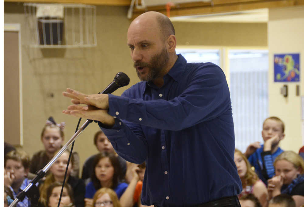 Photo by Megan Pacer/Peninsula Clarion Matt Boyle, a teacher at Nikiski North Star Elementary School and a veteran of the U.S. Coast Guard, tells stories from his time in the service to an audience on Wednesday, Nov. 11, 2015 at a Veterans Day assembly at the school in Nikiski, Alaska.