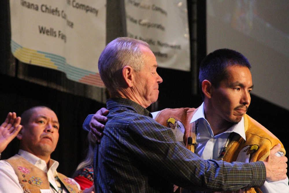Marvin Roberts, right, a member of the so-called Fairbanks Four, hugs his lawyer, Alaska Innocence Project attorney Bill Oberly during Roberts' address at the Alaska Federation of Natives conference in Anchorage, Alaska, Saturday, Oct. 17, 2015. Roberts and three other men were convicted of killing a Fairbanks teenager in 1997, but a post-conviction civil trial in being conducted in Fairbanks this month. The men, who have long claimed they were unjustly accused of the murder, are seeking to have their convictions overturned. (AP Photo/Mark Thiessen)